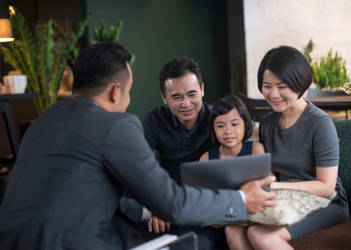 Family reviewing insurance documents with an advisor